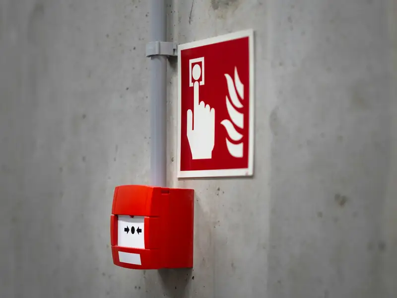 Fire alarm pull station mounted on a concrete wall